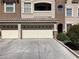 Attached garage with a three-car driveway and well-maintained landscaping at 8777 W Maule Ave # 2167, Las Vegas, NV 89148