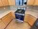 Kitchen featuring stainless steel gas range and custom wood cabinets at 8777 W Maule Ave # 2167, Las Vegas, NV 89148
