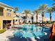 Community pool with seating areas, lounge chairs, and palm trees at 8777 W Maule Ave # 2167, Las Vegas, NV 89148