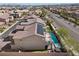 Aerial view of home displaying solar panels, pool, balcony, and lush backyard landscaping at 8895 Dartmouth Grove Ave, Las Vegas, NV 89148