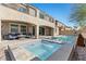 Luxurious backyard showcasing a pool, hot tub, comfortable seating, and covered patio for outdoor relaxation and entertainment at 8895 Dartmouth Grove Ave, Las Vegas, NV 89148