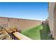 A charming backyard featuring lush artificial grass, a bench, and well-maintained landscaping at 8895 Dartmouth Grove Ave, Las Vegas, NV 89148