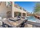 Spacious backyard with a modern pool, hot tub, outdoor dining area, and comfortable seating for entertaining at 8895 Dartmouth Grove Ave, Las Vegas, NV 89148