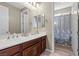 Bathroom with a double sink vanity and a view of the shower and toilet at 8895 Dartmouth Grove Ave, Las Vegas, NV 89148