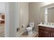 Neutral half bath featuring wood-look floors, a toilet and a vanity with a sink at 8895 Dartmouth Grove Ave, Las Vegas, NV 89148