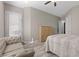 Bright bedroom with large windows, a cozy couch, and neutral decor for a tranquil retreat at 8895 Dartmouth Grove Ave, Las Vegas, NV 89148