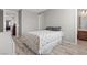 Bedroom with light wood floors and neutral walls adjacent to the ensuite bath at 8895 Dartmouth Grove Ave, Las Vegas, NV 89148