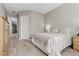 Cozy bedroom featuring a neutral color scheme, wood-look flooring, and natural light at 8895 Dartmouth Grove Ave, Las Vegas, NV 89148