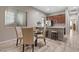 Cozy dining area with a modern table set near the kitchen, offering a view of the living area at 8895 Dartmouth Grove Ave, Las Vegas, NV 89148