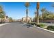 Gated community entrance featuring palm trees and well-manicured landscaping at 8895 Dartmouth Grove Ave, Las Vegas, NV 89148