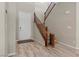 Bright entryway with beautiful staircase, wood flooring, and light grey walls at 8895 Dartmouth Grove Ave, Las Vegas, NV 89148