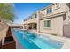 Exterior view of a two-story home featuring a pool, patio, and balcony, perfect for outdoor living and entertaining at 8895 Dartmouth Grove Ave, Las Vegas, NV 89148