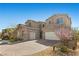 Charming two-story home boasts a stone accent, attached two car garage and a beautifully landscaped front yard at 8895 Dartmouth Grove Ave, Las Vegas, NV 89148