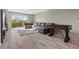 Spacious game room with comfortable seating, a foosball table, and a sliding glass door at 8895 Dartmouth Grove Ave, Las Vegas, NV 89148