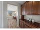 Hallway with natural light, leading to a bathroom with double sinks and stylish cabinetry at 8895 Dartmouth Grove Ave, Las Vegas, NV 89148