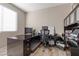 Well-lit home office with a large desk, ergonomic chair and a window providing natural light at 8895 Dartmouth Grove Ave, Las Vegas, NV 89148