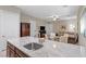 Stylish kitchen area featuring granite countertops, stainless steel sink, and views of an inviting seating area at 8895 Dartmouth Grove Ave, Las Vegas, NV 89148