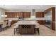 This open concept kitchen offers a large island with seating, stainless steel appliances, and wood cabinetry at 8895 Dartmouth Grove Ave, Las Vegas, NV 89148