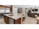 Spacious kitchen with granite countertops, stainless steel appliances, an island with seating, and an open floor plan at 8895 Dartmouth Grove Ave, Las Vegas, NV 89148