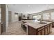 Open-concept kitchen with a large island and stainless steel appliances, seamlessly flowing into the living and dining areas at 8895 Dartmouth Grove Ave, Las Vegas, NV 89148