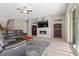 Spacious living room with a fireplace, tile floors, and a sliding glass door at 8895 Dartmouth Grove Ave, Las Vegas, NV 89148