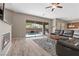Spacious living room with a fireplace, tile floors, and a sliding glass door leading to the backyard at 8895 Dartmouth Grove Ave, Las Vegas, NV 89148