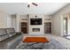 Bright living room with a fireplace, TV, wine storage, an area rug, and tile flooring at 8895 Dartmouth Grove Ave, Las Vegas, NV 89148