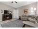 Inviting living room with a cozy fireplace and stylish sectional couch, perfect for relaxing at 8895 Dartmouth Grove Ave, Las Vegas, NV 89148