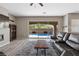 Open living room with a comfortable sofa and sliding glass doors overlooking the refreshing backyard pool at 8895 Dartmouth Grove Ave, Las Vegas, NV 89148