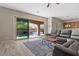 Comfortable living room with tile floors, an area rug, and sliding glass doors to the backyard at 8895 Dartmouth Grove Ave, Las Vegas, NV 89148