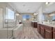 Bright main bathroom features a soaking tub, double vanities, and a large window with neighborhood views at 8895 Dartmouth Grove Ave, Las Vegas, NV 89148