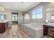Bright main bathroom featuring a separate shower, soaking tub and double vanities at 8895 Dartmouth Grove Ave, Las Vegas, NV 89148