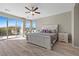 Bright main bedroom boasts a private balcony, ceiling fan, and stylish decor with lots of natural light at 8895 Dartmouth Grove Ave, Las Vegas, NV 89148