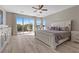 Bright main bedroom boasts a private balcony, ceiling fan, and stylish decor with lots of natural light at 8895 Dartmouth Grove Ave, Las Vegas, NV 89148