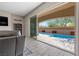 Covered patio area leads to the pool and the open living room with fireplace at 8895 Dartmouth Grove Ave, Las Vegas, NV 89148