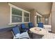 Covered patio featuring comfortable seating around a cozy fire pit at 8895 Dartmouth Grove Ave, Las Vegas, NV 89148