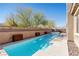Stunning lap pool complemented by verdant plantings and a decorative brick perimeter fence at 8895 Dartmouth Grove Ave, Las Vegas, NV 89148