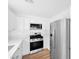 Modern kitchen equipped with stainless steel appliances, white cabinets, and stylish countertops at 9017 Becoming Ct, Las Vegas, NV 89149