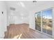 Bright living room with wood flooring and large sliding doors leading to a balcony or patio at 9017 Becoming Ct, Las Vegas, NV 89149