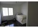 Small bedroom with dark floors, a bed, a window, and a closet at 9420 Water Flow Ct, Las Vegas, NV 89134