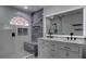 This bathroom features a double sink vanity, a blue marble shower with seating and a large, bright mirror at 9680 Granite Gorge Ct, Las Vegas, NV 89148