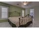 Bedroom with a metal frame bed, ceiling fan, and natural light coming through the windows at 9680 Granite Gorge Ct, Las Vegas, NV 89148