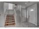 Bright entryway featuring tile floors, stairs with decorative runners, and a front door with sidelight at 9680 Granite Gorge Ct, Las Vegas, NV 89148