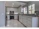 Bright kitchen featuring stainless steel appliances, white cabinetry, and modern backsplash at 9680 Granite Gorge Ct, Las Vegas, NV 89148
