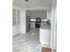 Bright kitchen with stainless steel appliances, white cabinets and marble floors at 9680 Granite Gorge Ct, Las Vegas, NV 89148