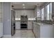 Modern kitchen featuring stainless steel appliances, sleek white cabinets, and a stylish tile backsplash at 9680 Granite Gorge Ct, Las Vegas, NV 89148