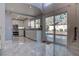 Open kitchen featuring white cabinetry, stainless steel appliances, marble floors, and backyard views at 9680 Granite Gorge Ct, Las Vegas, NV 89148