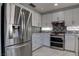 Kitchen showcasing stainless steel refrigerator, white cabinetry, and contemporary backsplash at 9680 Granite Gorge Ct, Las Vegas, NV 89148