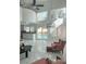 Bright living room with pool view, high ceilings, modern light fixture, and marble floors at 9680 Granite Gorge Ct, Las Vegas, NV 89148