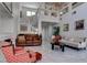 Bright living room with high ceilings, large windows, tile floors, and comfortable seating at 9680 Granite Gorge Ct, Las Vegas, NV 89148